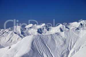 off-piste slope with traces of skis and snowboards in nice day