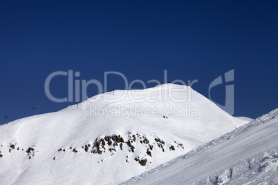 ski slope and ropeway at nice winter day