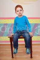 child sits on the stool