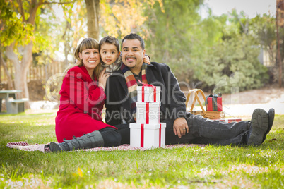 mixed race family enjoying valentine's gifts in the park together