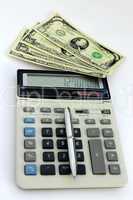 dollar bank notes, calculator and pen