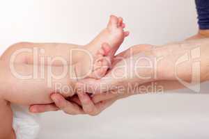 mother hands holding baby feet