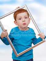 boy holding picture frame