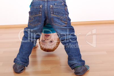 child looking through his legs