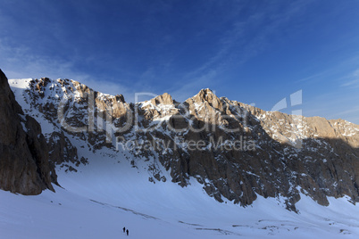 hikers on snowy mountains in morning