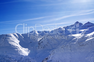 snowy sunlight mountains at nice evening, view from off piste sl