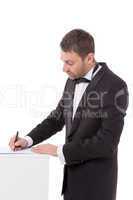 man in a bow tie completing a form