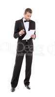 man in a tuxedo reading the document