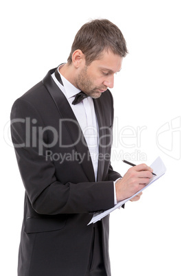 handsome man in a bow tie writing notes