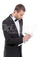 handsome man in a bow tie writing notes