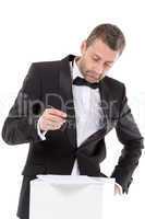 man in a bow tie completing a form