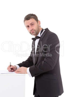 man in a bow tie completing a form