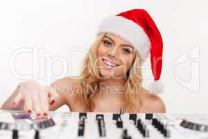 young brunette woman in christmas wear with dj equipment