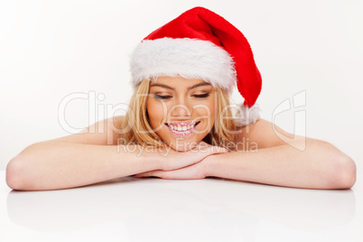 young woman in santa claus hat posing isolated on white