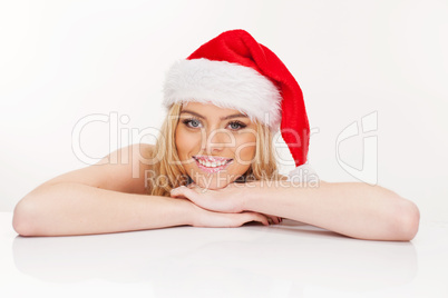 young woman in santa claus hat posing isolated on white