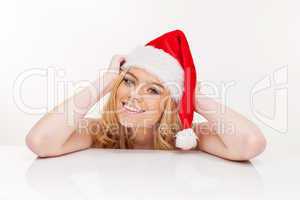 young woman in santa claus hat posing isolated on white