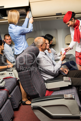 flight attendant check passenger tickets cabin