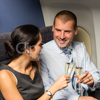 flight cabin business partners toasting champagne
