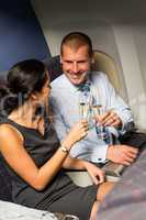 smart couple travel by airplane toasting champagne