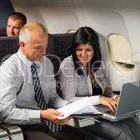 businesspeople working on computer flight airplane