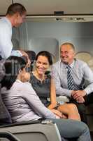 business people passengers flying airplane talking
