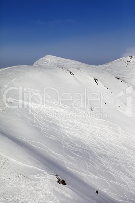 off-piste ski slope with traces