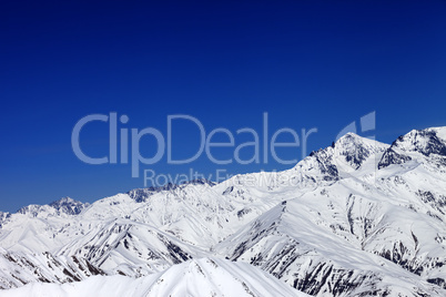 winter snowy mountains and blue sky