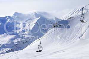 chair lifts and off-piste slope in haze