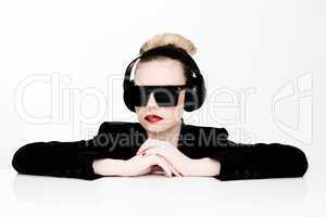 sexy woman in sunglasses listening to music