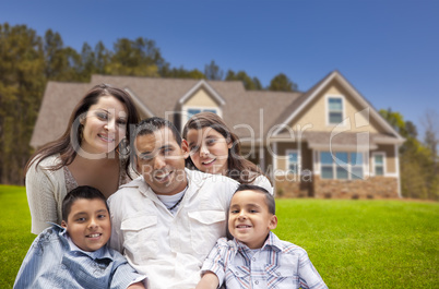 young hispanic family in front of their new home