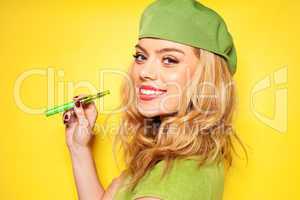 trendy woman in green with an e-cigarette