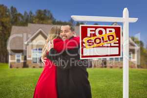 mixed race couple, house, sold real estate sign