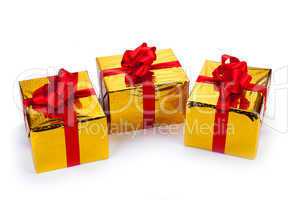 three gold gift boxes