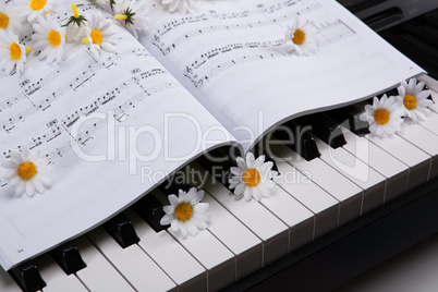 piano keys and musical book and flower