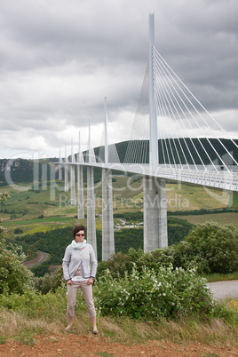woman in front of millau bridge