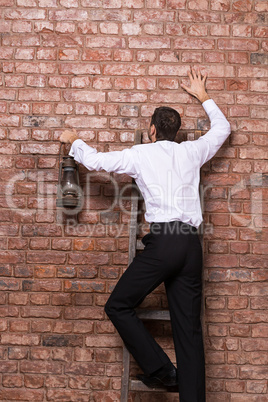 man up against a brick wall