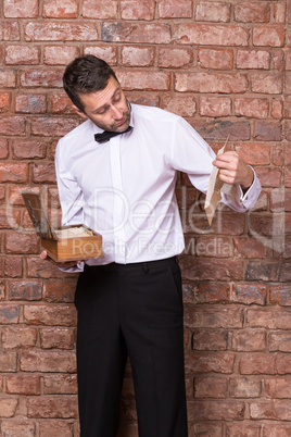 man reading a document from a wooden box