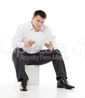 businessman reading a report with scepticism