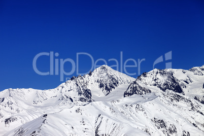 winter snowy mountains and blue clear sky