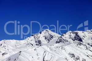 winter snowy mountains and blue clear sky