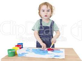 cute girl painting on small desk looking to camera