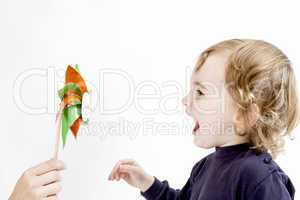 cute girl blowing to windmill