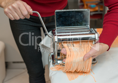 Woman Chef making simple homemade noodles with pasta machine.