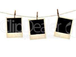 old style photographs hanging on a clothesline