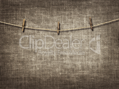 clothesline with clothespins on linen background