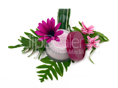 Cosmetic pink cream with herbs and flowers