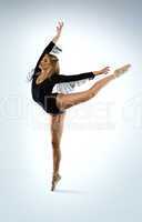 beautiful ballet dancer doing an arabesque