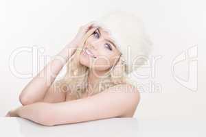 beautiful naked blond girl in a white winter hat