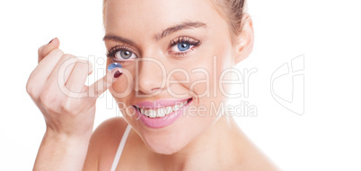 beautiful woman inserting a contact lens