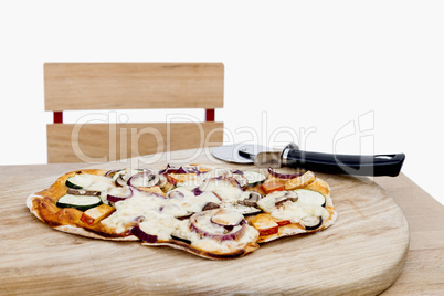 pizza with cutter on small desk